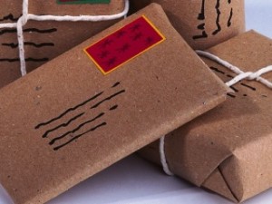 Pile of four parcels wrapped in brown paper and string